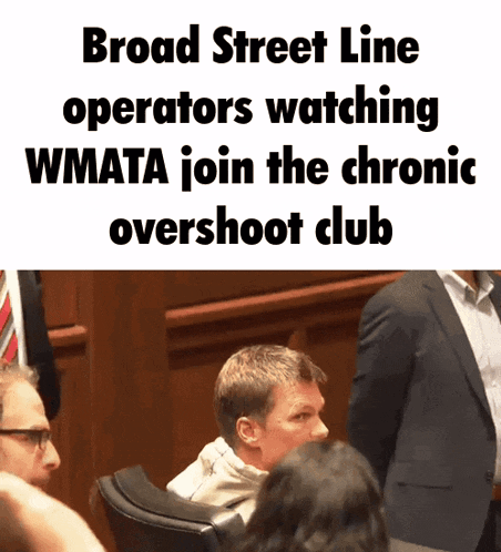 a man in a suit sits in front of a sign that says broad street line operators watching wmata join the chronic overshot club