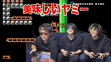 three men are sitting on a couch playing a video game that says start in red letters
