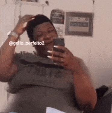 a man is taking a picture of himself in a mirror while holding a cell phone .