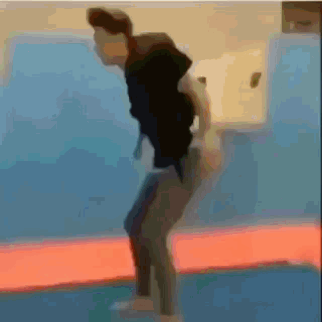 a blurry picture of a person doing a trick on a basketball court
