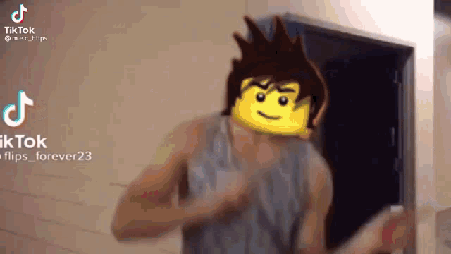 a man with a lego face on his head is dancing .