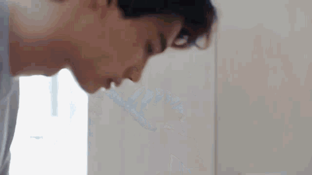 a man is looking at himself in a mirror .