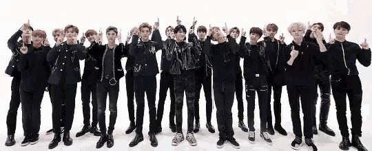 a group of young men are standing next to each other in a row .