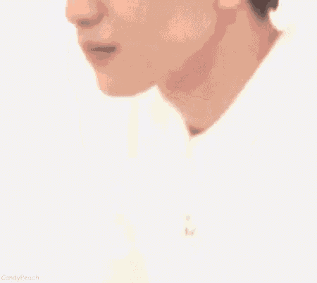 a close up of a young man 's face with his eyes closed and a smile on his face .