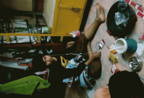 a person laying on the floor with a coca cola bottle in their lap
