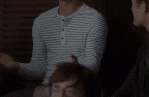 a man in a striped shirt with buttons on the front