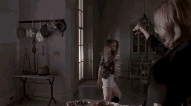 a blurry picture of a woman standing in a room