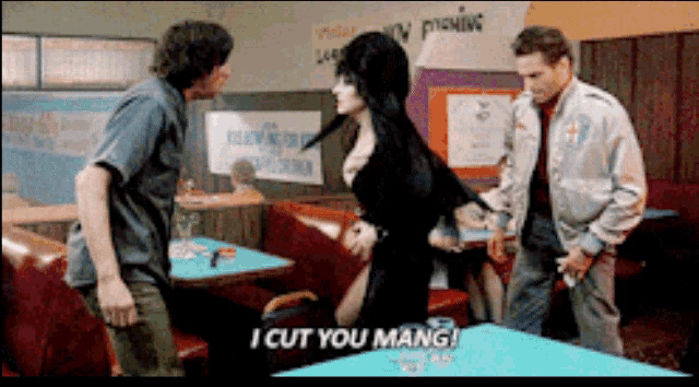 a woman in a black dress says " i cut you mang " in a restaurant