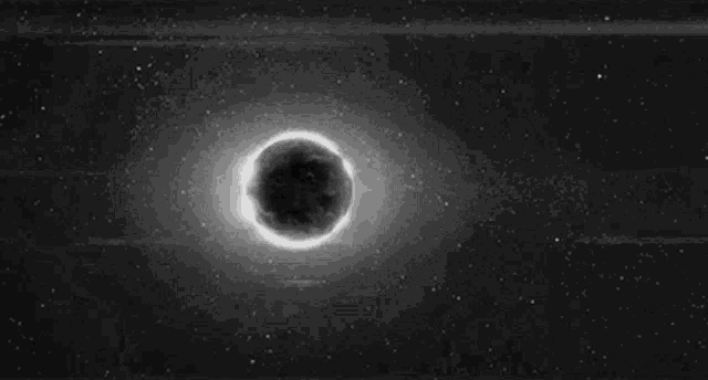 a close up of a person 's eye with a light coming out of it in the dark .