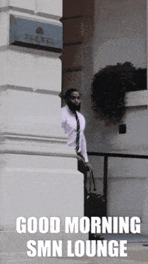 a man carrying a suitcase is standing in front of a building that says good morning smn lounge
