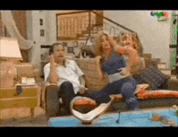 a group of people are sitting on a couch in a room