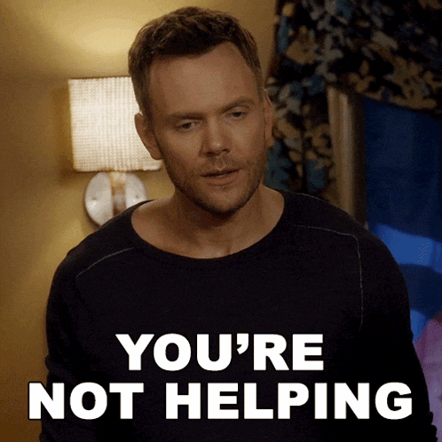 a man in a black shirt says " you 're not helping " in white letters