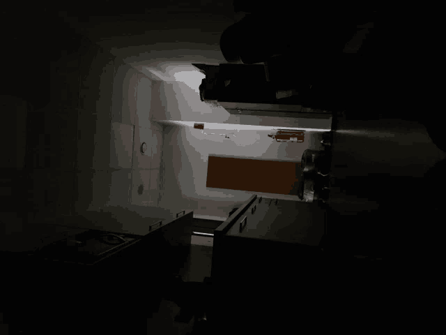 a dark room with a red box on the wall