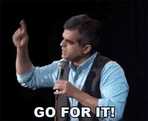 a man is giving a speech in front of a microphone and saying go for it .