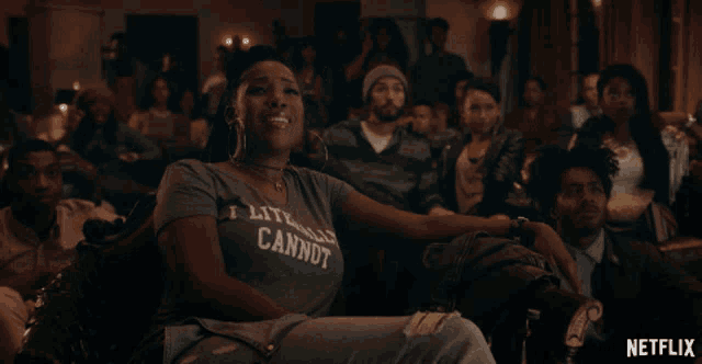 a woman wearing a t-shirt that says i literally cannot sits in a crowd of people