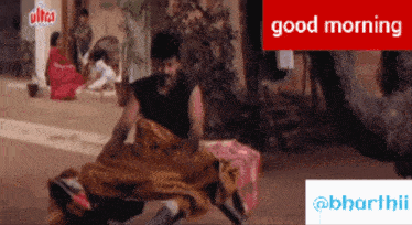 a man in a black shirt is laying on a bed with the words good morning on the bottom