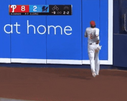 two baseball players standing in front of a wall that says home