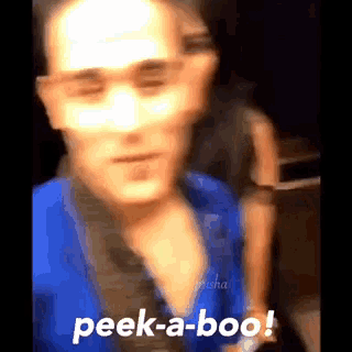 a blurry photo of a man with the words peek-a-boo on the bottom