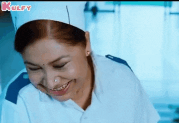 a woman in a nurse 's uniform is smiling and laughing in a hospital room .