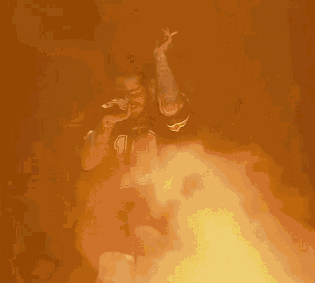 a person is surrounded by flames and smoke with their hand reaching up