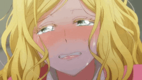 a woman with blonde hair is crying with her eyes closed and her mouth open .