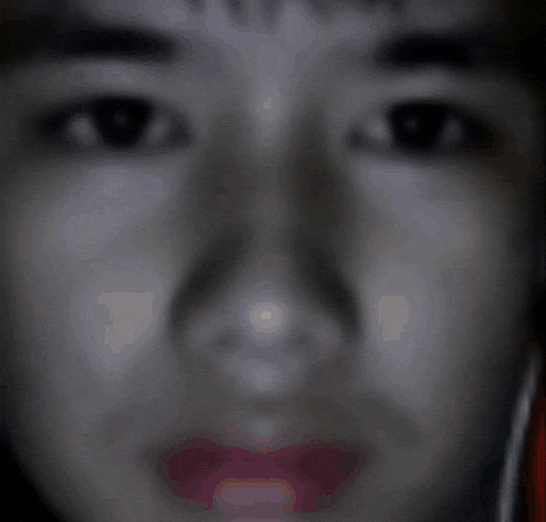 a close up of a person 's face with a red lip
