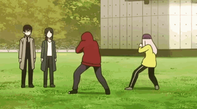 a group of people are standing in a field .