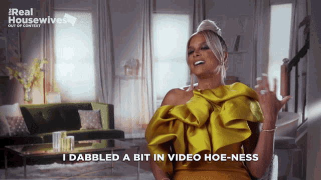 a woman in a yellow dress says i dabbled a bit in video hoeness