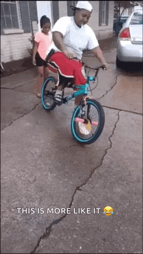 a man is riding a bike with a little girl on the back and the caption " this is more like it "