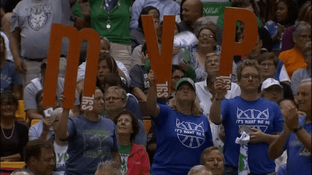 a crowd of people holding signs that say mvp