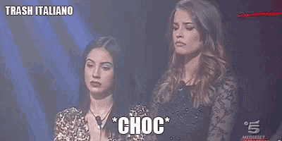 two women are standing next to each other and one of them is saying " choc " .