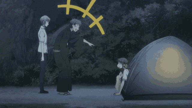 a group of people standing around a tent with a yellow x in the background
