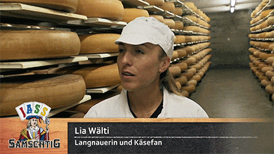 a woman standing in front of a sign that says lia walti langnauerin und kasefan
