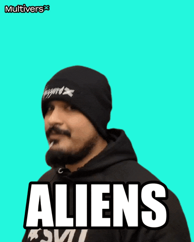 a man with a beard wearing a black beanie says aliens on a blue background