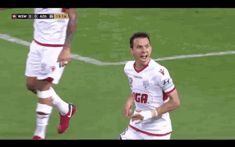 a soccer player wearing a white jersey with a red g on the front