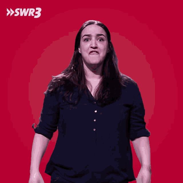 a woman is making a funny face in front of a red background with swr3