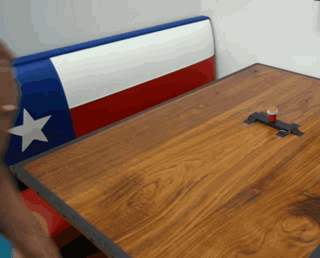 a wooden table with a red white and blue texas flag on it