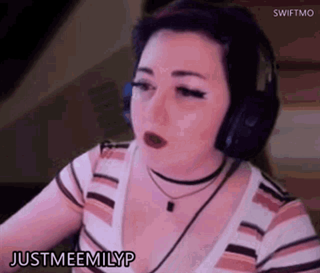 a woman wearing headphones and a choker says justmeemilyp .