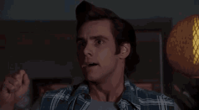 a man is making a funny face with his mouth open .