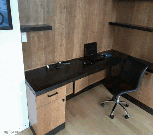 a desk with a laptop on it and a chair in front of it with ingflip.com written on the bottom