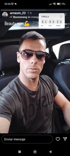 a man wearing sunglasses is sitting in the back seat of a car with a boomerang on his phone