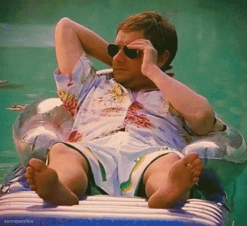 a man wearing sunglasses sits on a raft in the water