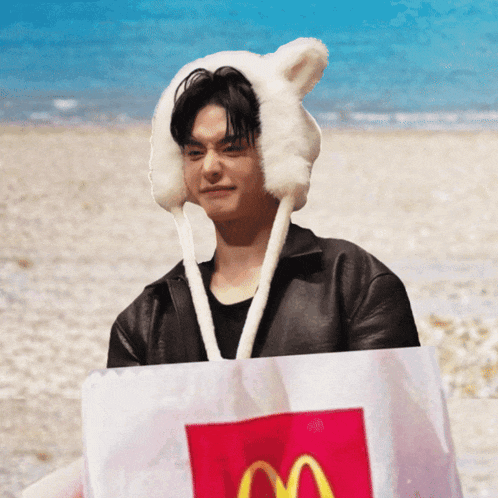 a man wearing a furry hat holds a bag of mcdonald 's