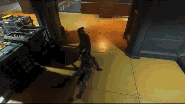 a video game is being played in a room with a yellow floor and a few boxes