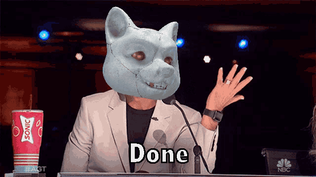 a man with a cat mask on his head says " done "