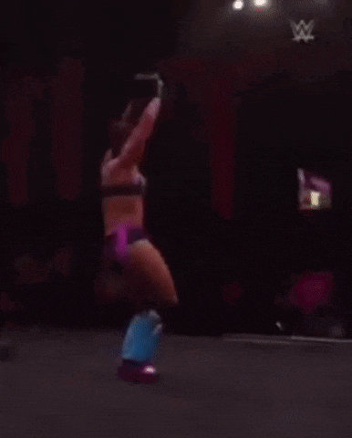 a woman in a bra and shorts is dancing on a stage .