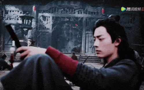 a man in a black jacket is holding a sword in front of a building with chinese characters on the screen