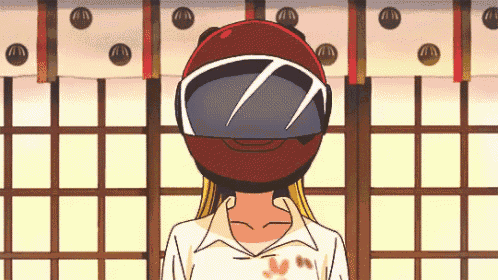 a girl wearing a red helmet and goggles stands in a room