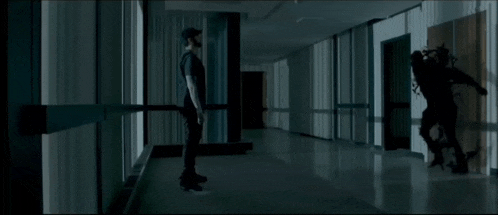 a person standing in a hallway with a knife