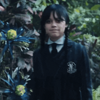a girl in a school uniform with the letters snl on her badge